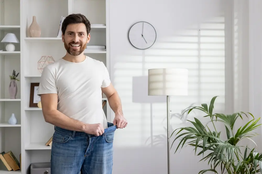 Man standing confidently after completing a medically supervised weight loss program